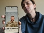 Ukrainian servicewoman Svitlana Povar shows on her mobile phone a photograph of her late husband, Ukrainian soldier Semen Povar. Ukrainian servicewoman Svitlana Povar shows on her mobile phone a photograph of her late husband, Ukrainian soldier Semen Povar.