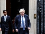 Former British Prime Minister Boris Johnson and Rishi Sunak walking out of Downing Street