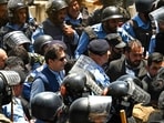 Policemen escort Pakistan's former Prime Minister Imran Khan (C) as he arrives at the high court in Islamabad on Friday. Policemen escort Pakistan's former Prime Minister Imran Khan (C) as he arrives at the high court in Islamabad on Friday.