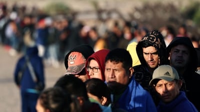Immigrants seeking asylum in the United States wait in line before sunrise to be processed by US Border Patrol agents after crossing into Arizona from Mexico on May 11 in Yuma, Arizona. The Border Patrol stopped some 10,000 migrants on Tuesday — nearly twice the average daily level from March and only slightly below the 11,000 figure that authorities have said is the upper limit of what they expect after Title 42 ends, one U.S. official said. (Mario Tama / Getty Images / AFP ) Immigrants seeking asylum in the United States wait in line before sunrise to be processed by US Border Patrol agents after crossing into Arizona from Mexico on May 11 in Yuma, Arizona. The Border Patrol stopped some 10,000 migrants on Tuesday — nearly twice the average daily level from March and only slightly below the 11,000 figure that authorities have said is the upper limit of what they expect after Title 42 ends, one U.S. official said. (Mario Tama / Getty Images / AFP )