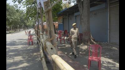 A UP police personnel guarding the EVM machine and ballot paper ballot box outside the strong room and counting station at Anaj Mandi in Ghaziabad. (Sakib Alli/HT Photo)