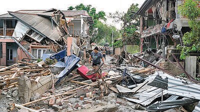 A woman walks through the wreckage of a building that was set on fire during clashes, in Manipur’s Khumujamba village. (AFP) A woman walks through the wreckage of a building that was set on fire during clashes, in Manipur’s Khumujamba village. (AFP)