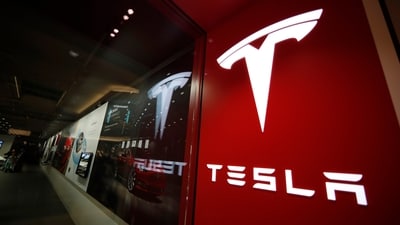 A sign bearing the Tesla company logo is displayed outside a Tesla store. (AP) A sign bearing the Tesla company logo is displayed outside a Tesla store. (AP)