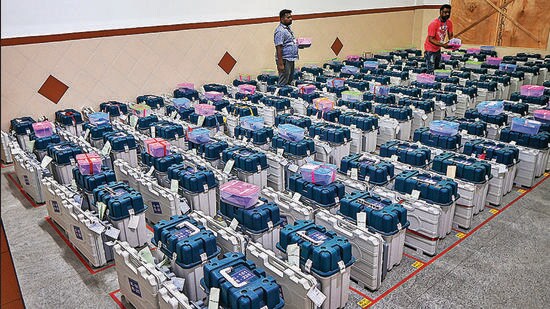 Workers arrange EVMs in a strong room after the Karnataka assembly elections, in Bengaluru. (PTI)