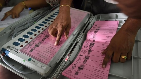 A polling staff tallies the candidates’ names on the Electronic Voting Machines (EVM) during Karnataka elections. A polling staff tallies the candidates’ names on the Electronic Voting Machines (EVM) during Karnataka elections.