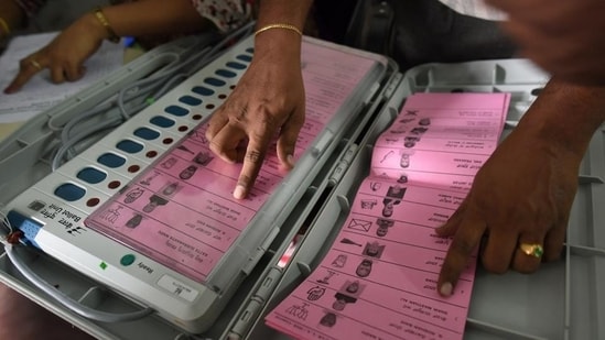 A polling staff tallies the candidates’ names on the Electronic Voting Machines (EVM) during Karnataka elections