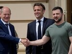 German Chancellor Olaf Scholz, left, shakes hands with Ukrainian President Volodymyr Zelenskyy, right, as French President Emmanuel Macron smiles at the Mariyinsky Palace in Kyiv, Ukraine, Thursday, June 16, 2022. German Chancellor Olaf Scholz, left, shakes hands with Ukrainian President Volodymyr Zelenskyy, right, as French President Emmanuel Macron smiles at the Mariyinsky Palace in Kyiv, Ukraine, Thursday, June 16, 2022.