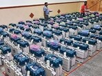 Workers arrange EVMs in a strong room after the Karnataka assembly elections, in Bengaluru. (PTI)