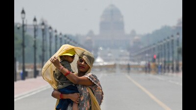 A mother and child shield themselves from the hot sunny day in Delhi on Saturday. (Raj K Raj/HT Photo) A mother and child shield themselves from the hot sunny day in Delhi on Saturday. (Raj K Raj/HT Photo)