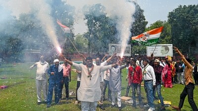 Congress supporters burst firecrackers as they celebrate the party's lead in the Karnataka Assembly election results, at party office in New Delhi. (ANI) Congress supporters burst firecrackers as they celebrate the party's lead in the Karnataka Assembly election results, at party office in New Delhi. (ANI)