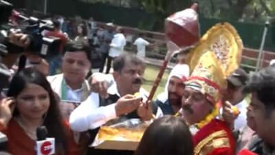 Congress leaders were seen distributing and eating laddoos. A Congress leader was also seen dressed as lord Hanuman outside the party's Delhi office. (Twitter/ANI)