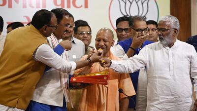 Chief minister Yogi Adityanath celebrates the party’s victory at BJP headquarters in Lucknow in Uttar Pradesh on Saturday. (Deepak Gupta/HT Photo)