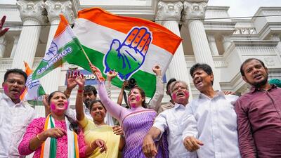 Congress leaders and workers celebrate at the party office in Bengaluru. (PTI)