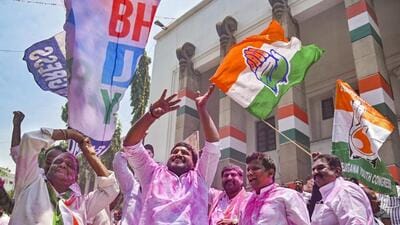 Congress workers celebrate. (PTI) Congress workers celebrate. (PTI)