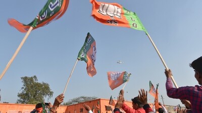 Party supporters hold BJP flags in UP. (File photo/PTI) Party supporters hold BJP flags in UP. (File photo/PTI)