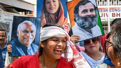 Congress supporters celebrate the party's good show in Karnataka Assembly polls at the Rajiv Bhawan, in Guwahati. (PTI) Congress supporters celebrate the party's good show in Karnataka Assembly polls at the Rajiv Bhawan, in Guwahati. (PTI)