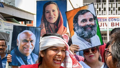Congress supporters celebrate the party's good show in Karnataka Assembly polls (PTI) Congress supporters celebrate the party's good show in Karnataka Assembly polls (PTI)