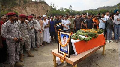 Security personnel and locals pay tributes to Indian Navy’s petty officer Ankush Sharma on Saturday. (PTI)
