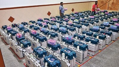 Workers arrange EVMs in a strong room after the Karnataka assembly elections, in Bengaluru. (PTI) Workers arrange EVMs in a strong room after the Karnataka assembly elections, in Bengaluru. (PTI)