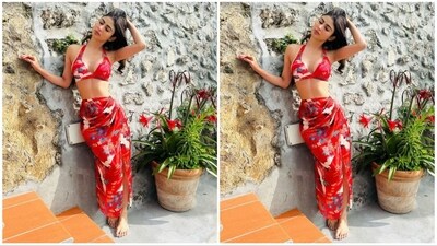 Mouni donned a gorgeous red outfit that includes a bikini top with a halter neck and a deep sweetheart neckline. She paired it with a similarly printed thigh-high slit skirt (Instagram/@imouniroy) Mouni donned a gorgeous red outfit that includes a bikini top with a halter neck and a deep sweetheart neckline. She paired it with a similarly printed thigh-high slit skirt (Instagram/@imouniroy)