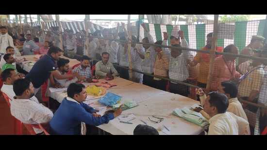 Election officials counting votes at Rajapur Mandi Samiti in Lakhimpur on Saturday. (HT Photo)
