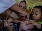 A health worker gives a polio vaccine to a child at a Healthcare Center in Bogor, West Java. 