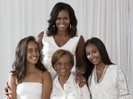 Perfect for the occasion, this priceless picture shows Michelle Obama, her mom Marian Lois Robinson and her two lovely daughters Malia and Sasha - all clad in white, sit prettily.