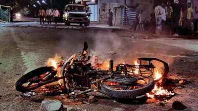 A vehicle set on fire during the communal clash in Maharashtra’s Akola city on Saturday. (PTI)
