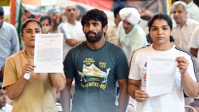 New Delhi, May 14 (ANI): Wrestlers Vinesh Phogat, Bajrang Punia and Sakshi Malik address a press conference during their ongoing protest against the Wrestling Federation of India (WFI) chief Brij Bhushan Sharan Singh over the alleged harassment of women wrestlers, at Jantar Mantar, in New Delhi on Sunday. (ANI Photo/Shrikant Singh) (Shrikant Singh) New Delhi, May 14 (ANI): Wrestlers Vinesh Phogat, Bajrang Punia and Sakshi Malik address a press conference during their ongoing protest against the Wrestling Federation of India (WFI) chief Brij Bhushan Sharan Singh over the alleged harassment of women wrestlers, at Jantar Mantar, in New Delhi on Sunday. (ANI Photo/Shrikant Singh) (Shrikant Singh)