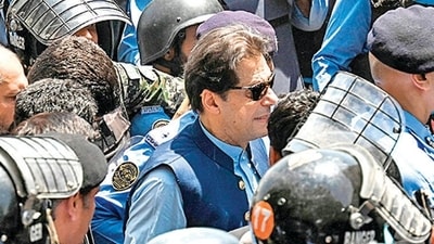 Imran Khan: Policemen escort Pakistan's former Prime Minister Imran Khan as he arrives at the high court in Islamabad. (AFP) Imran Khan: Policemen escort Pakistan's former Prime Minister Imran Khan as he arrives at the high court in Islamabad. (AFP)