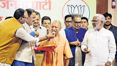 Uttar Pradesh chief minister Yogi Adityanath celebrates BJP’s victory in the civic body polls at the state party office in Lucknow on Saturday. (ANI) Uttar Pradesh chief minister Yogi Adityanath celebrates BJP’s victory in the civic body polls at the state party office in Lucknow on Saturday. (ANI)