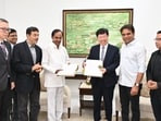 Telangana CM Chandrashekar Rao along with Foxconn Chairman Young Liu receiving official documents related to the company's investment in the state.