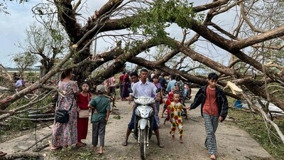 Residents walk past fallen trees in Kyauktaw in Myanmar's Rakhine state on May 15, after Cyclone Mocha crashed ashore in Myanmar and southeastern Bangladesh on May 14. The cyclone carried winds of up to 195 kilometres (120 miles) per hour uprooting trees, scattering flimsy homes in Rohingya displacement camps, and bringing a storm surge into low-lying areas, reported AFP. (Sai Aung Main / AFP) Residents walk past fallen trees in Kyauktaw in Myanmar's Rakhine state on May 15, after Cyclone Mocha crashed ashore in Myanmar and southeastern Bangladesh on May 14. The cyclone carried winds of up to 195 kilometres (120 miles) per hour uprooting trees, scattering flimsy homes in Rohingya displacement camps, and bringing a storm surge into low-lying areas, reported AFP. (Sai Aung Main / AFP)