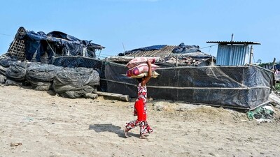 A girl carries her belongings as she returns from a shelter in Shah Porir Dwip island on the outskirts of Teknaf, Bangladesh. Residents of the island began repairing damaged homes, searching through debris, and retrieving scattered possessions. Bangladesh officials said they had evacuated 750,000 people, reported AFP. (Munir uz Zaman / AFP) A girl carries her belongings as she returns from a shelter in Shah Porir Dwip island on the outskirts of Teknaf, Bangladesh. Residents of the island began repairing damaged homes, searching through debris, and retrieving scattered possessions. Bangladesh officials said they had evacuated 750,000 people, reported AFP. (Munir uz Zaman / AFP)
