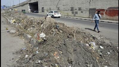 A view of debris dumped after cleaning the sewage near Vinod Nagar, in New Delhi on Monday. (Sanjeev Verma/HT)
