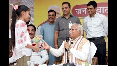 Haryana chief minister Manohar Lal Khattar interacts with a child in Sirsa on Monday. Haryana chief minister Manohar Lal Khattar interacts with a child in Sirsa on Monday.