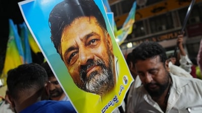 Supporters of senior Congress leader DK Shivakumar outside the venue of the Congress Legislature Party (CLP) meeting in Bengaluru on Sunday. (PTI) Supporters of senior Congress leader DK Shivakumar outside the venue of the Congress Legislature Party (CLP) meeting in Bengaluru on Sunday. (PTI)