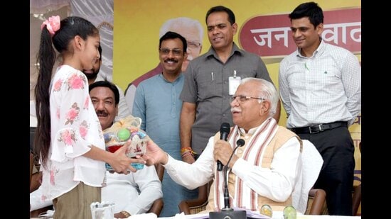 Haryana chief minister Manohar Lal Khattar interacts with a child in Sirsa on Monday.