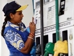A woman employee works at a petrol pump in Kolkata.