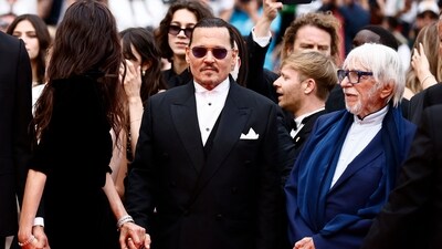 A coterie of stars streamed down Cannes' famous red carpet for the opening night ceremony, including Brie Larson, Uma Thurman, Gong Li, Elle Fanning, Catherine Deneuve (who graces this year's festival poster) and a blue-haired Helen Mirren, who carried a fan labeled #worthit. (REUTERS)