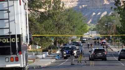 Investigators work along a residential street following a deadly shooting. (AP) Investigators work along a residential street following a deadly shooting. (AP)