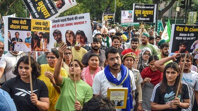 Wrestlers Vinesh Phogat, Sakshi Malik and Sangeeta Phogat with Bhim Army chief Chandra Shekhar Azad and others march towards Connaught Place to protest against Wrestling Federation of India chief Brij Bhushan Sharan Singh (PTI) Wrestlers Vinesh Phogat, Sakshi Malik and Sangeeta Phogat with Bhim Army chief Chandra Shekhar Azad and others march towards Connaught Place to protest against Wrestling Federation of India chief Brij Bhushan Sharan Singh (PTI)