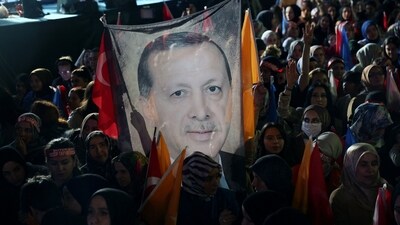 Turkey Elections: Supporters of Turkish President Tayyip Erdogan holds a flag of his portrait outside the AK Party headquarters after polls closed. (AFP) Turkey Elections: Supporters of Turkish President Tayyip Erdogan holds a flag of his portrait outside the AK Party headquarters after polls closed. (AFP)