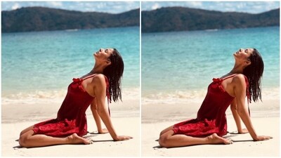 Shehnaaz posed by the beach in a little red dress and gave us major travel fashion goals. (Instagram/@shehnaazgill) Shehnaaz posed by the beach in a little red dress and gave us major travel fashion goals. (Instagram/@shehnaazgill)
