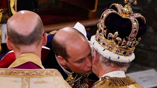 Prince William kisses his father King Charles III during his coronation ceremony at Westminster Abbey in London. (AP)