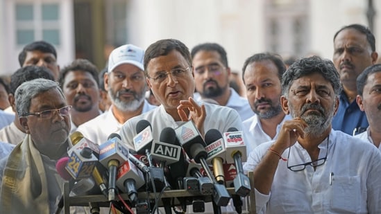 Congress leader Randeep Singh Surjewala with party leaders DK Shivakumar and Siddaramaiah. (ANI)