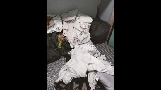 Unclean bedsheets and pillows piled-up in the train are given to passengers. (HT PHOTO)