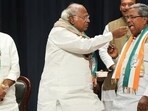Congress president Mallikarjun Kharge offers sweets to Siddaramaiah during celebrations after the party's win in Karnataka Assembly elections, as state unit chief DK Shivakumar looks on. (PTI)