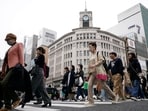 People walk at a pedestrian crossing in Ginza shopping district Friday in Tokyo, Japan.