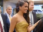 Meghan Markle arrived in a strapless gold gown at the event on Tuesday. Prince Harry also joined her.